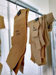 several pieces of brown paper hanging from hooks