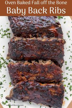 baby back ribs on a white plate with parsley and text overlay that reads oven baked fall off the bone baby back ribs