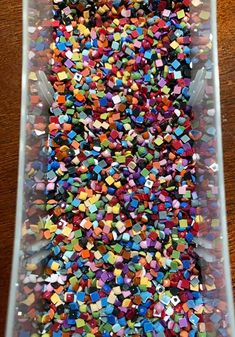 a plastic container filled with lots of colorful sprinkles