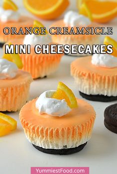 orange creamsice mini cheesecakes are topped with whipped cream and an orange slice