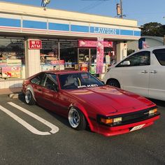 a red car parked in front of a store