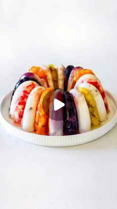 a white plate topped with sliced fruit on top of a table