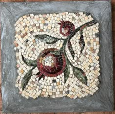 a mosaic tile with flowers on it