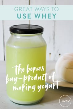 a glass jar filled with liquid next to garlic on top of a wooden table and the words great ways to use whey