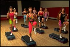 a group of young women standing on top of exercise mats