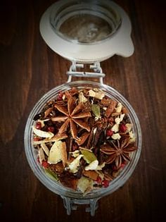 an overhead view of a blender filled with fruit and nutmeal mix on a wooden table