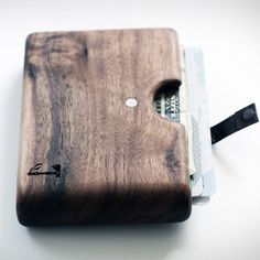 a wooden wallet sitting on top of a white table