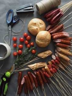 an assortment of meats and vegetables on skewers next to scissors, sprigs of rosemary