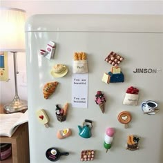 a refrigerator with magnets attached to it