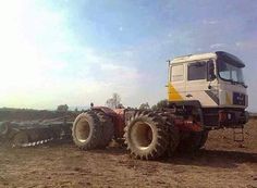 a large tractor is parked in the dirt