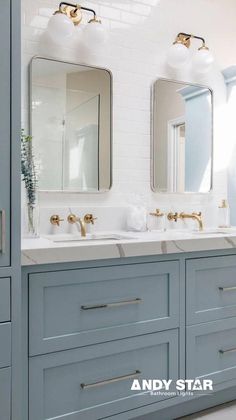 a bathroom with two sinks and mirrors on the wall