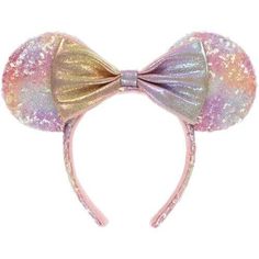 a pink and gold mouse ears headband with sequins on the ears that has a bow at the top