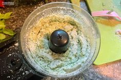 a food processor filled with flour on top of a counter