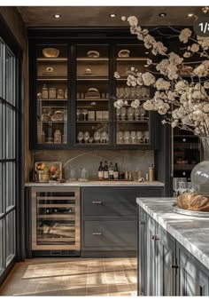 a kitchen filled with lots of counter top space next to a wine rack and cabinets