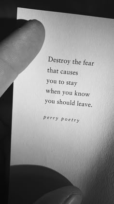 a person holding up a piece of paper with the words destroy the fear that cause you to stay when you know you should leave