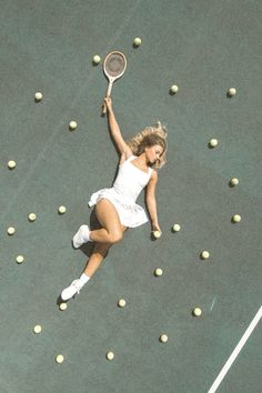 a female tennis player in mid air after hitting the ball with her racquet