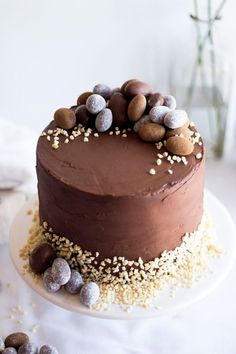 there is a chocolate cake with nuts on the top and frosting in the middle