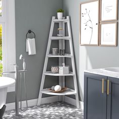 a bathroom with grey walls and a white shelf in the corner next to a bathtub