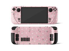 a pink nintendo wii game console with flowers and dots on the side, it is shown