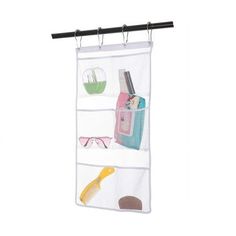 an over the door hanging organizer with three pockets and two pairs of eyeglasses