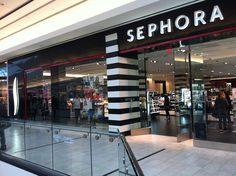 a sephora store front with people walking by