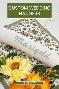 a bouquet of flowers sitting on top of a table next to an orange and white napkin