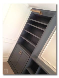 an empty bookcase in the corner of a room