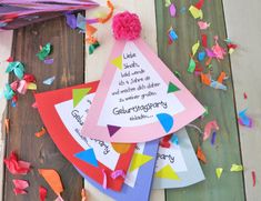 a birthday party hat with confetti and streamers on the floor next to it