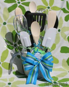 an arrangement of kitchen utensils in a vase