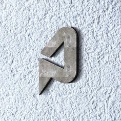 the letter c is made out of concrete and has an arrow on it's side