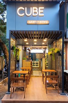 the inside of a restaurant with wooden tables and chairs