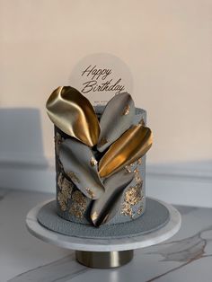 a birthday cake with gold and silver decorations