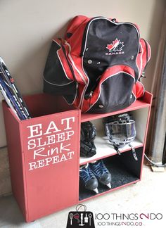 a red shelf with some skis and bags on it