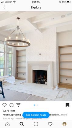 an instagramted photo of a living room with white walls and open shelving