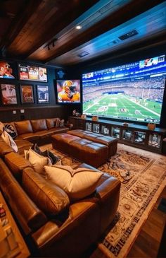 a living room with couches and televisions in the wall mounted to the ceiling