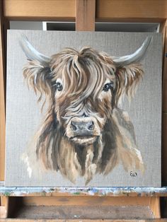 a painting of a brown cow with long horns on it's head is shown