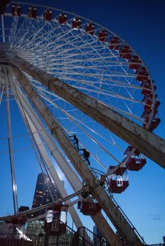 a large ferris wheel sitting next to a tall building