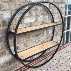 a metal and wood shelf on the side of a brick wall