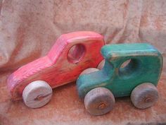 two wooden toy cars sitting next to each other