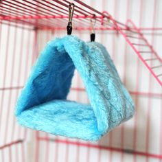 a blue cat bed hanging from a wire