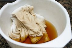 a white bowl filled with liquid and cloth