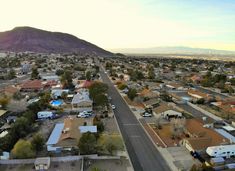 an aerial view of a small town with mountains in the background