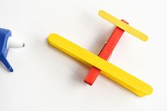 two popsicle shaped magnets sitting next to each other on a white table top