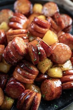 a plate full of cooked sausages and potatoes