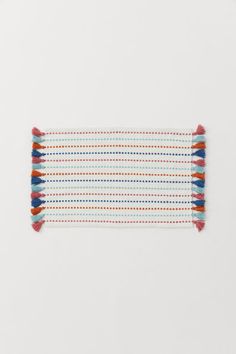 multicolored striped table runner with tassels