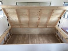 the inside of a trailer with wood flooring and walls in place to allow storage