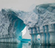 an iceberg in the water with rocks and snow on it