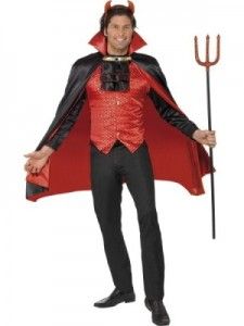 a man dressed in devil costume holding a pitchfork and wearing a red cape with horns