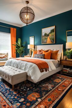 a bed sitting in a bedroom next to a window covered in orange and blue curtains