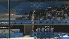 a man jumping into the air on top of a diving board in front of an audience